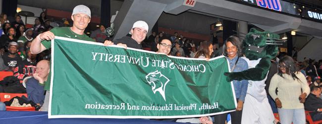 Students actively participating at a CSU basketball game and interacting with the team mascot (Cougar) in the JDC gymnasium